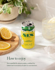 Can of Six Lemonade with lemons and a glass on a light surface