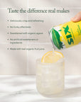 SIXS sparkling lemonade being poured into a glass with a lemon slice, against a white tiled background on a white marble surface