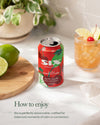 Six cherry lime can on a table with a drink of cherries and limes